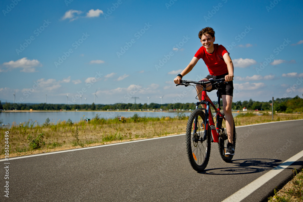Urban biking - teenage boy riding bike 