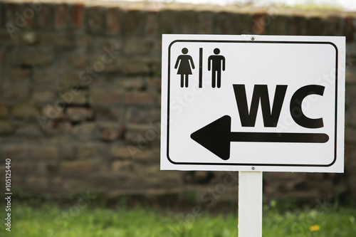 Toilet sing for man and female on white table in nature