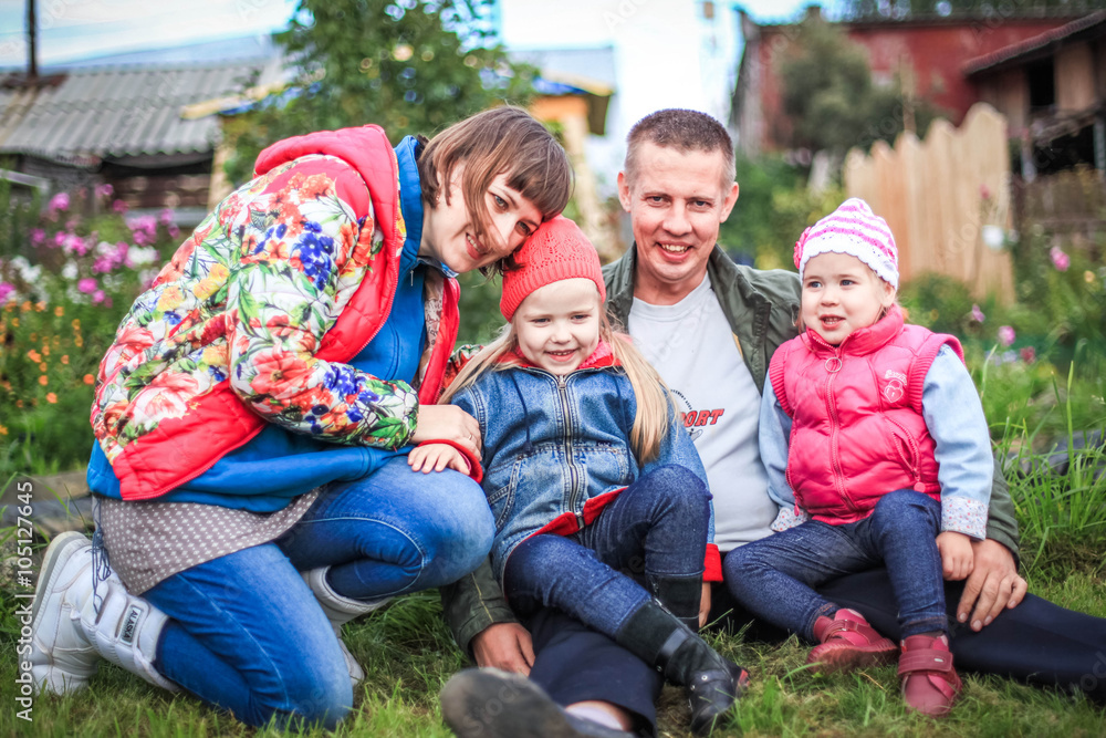 happy young couple with their children have fun at beautiful park outdoor in nature. happiness a family