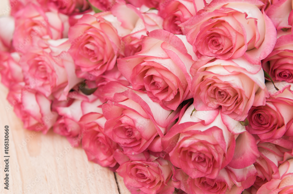 Beautiful pink roses on a dark wooden table Beautiful pink roses on a dark wooden table