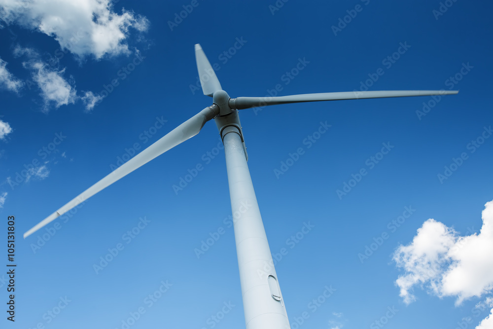 Wind generator turbine against deep blue sky with clouds Wind generator turbine against deep blue sky with clouds
