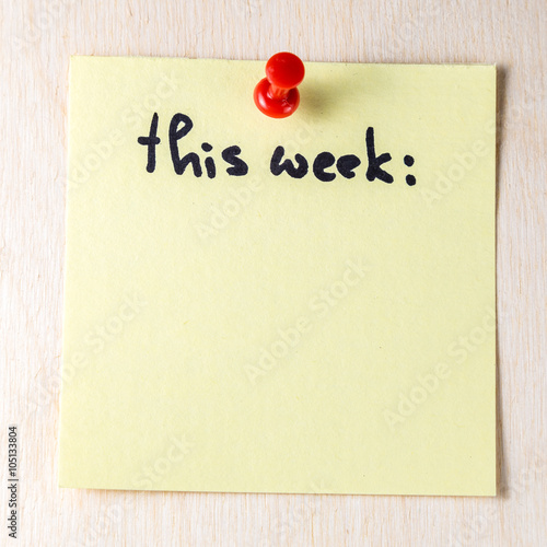 This week note on paper post it pinned to a wooden board photo