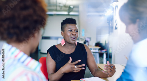 Plus size African american woman talking at meeting