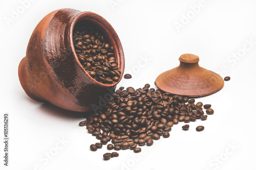 Grains of coffee in a decorative pot
