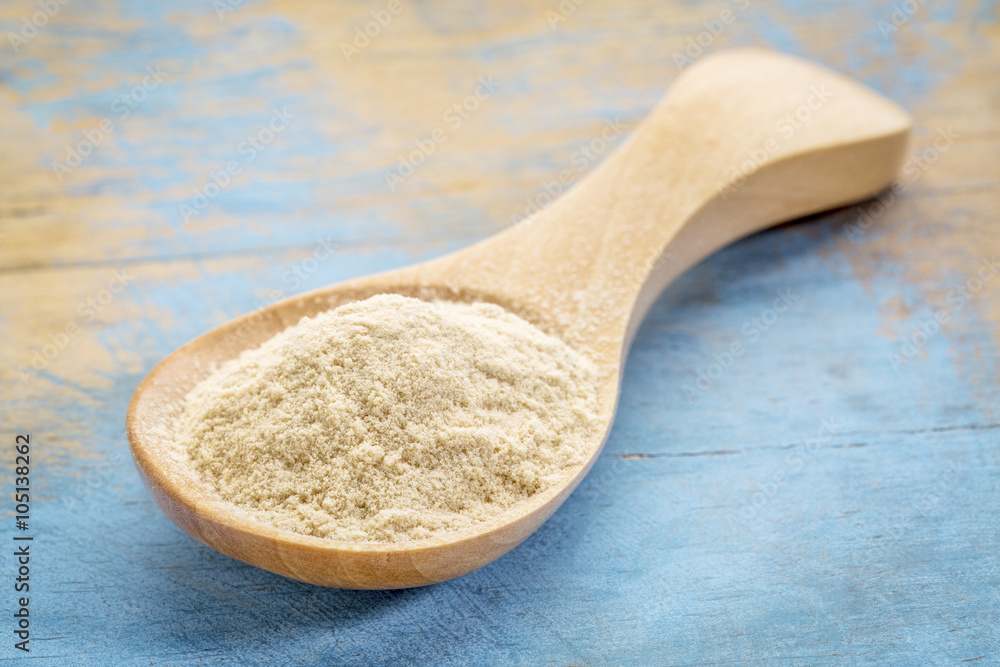 baobab fruit powder on wooden spoon baobab fruit powder on wooden spoon