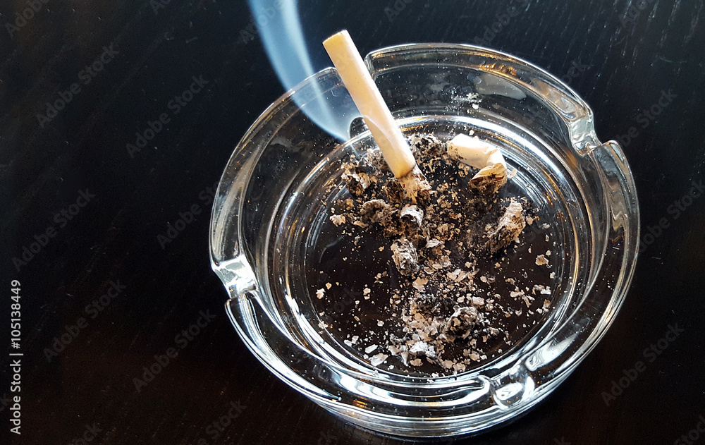 Still life cigarette and glass ashtray Still life cigarette and glass ashtray
