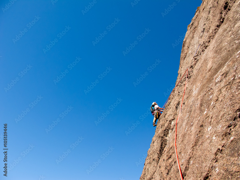 Rock climber climbing a sloping rock wall in Brazil