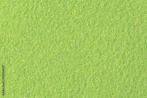 Lime glitter background. Low contrast photo.