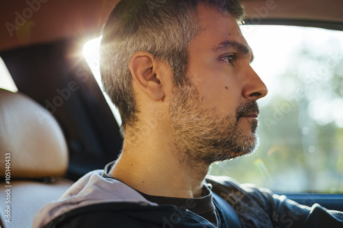 Close up portrait of a man driving a car.