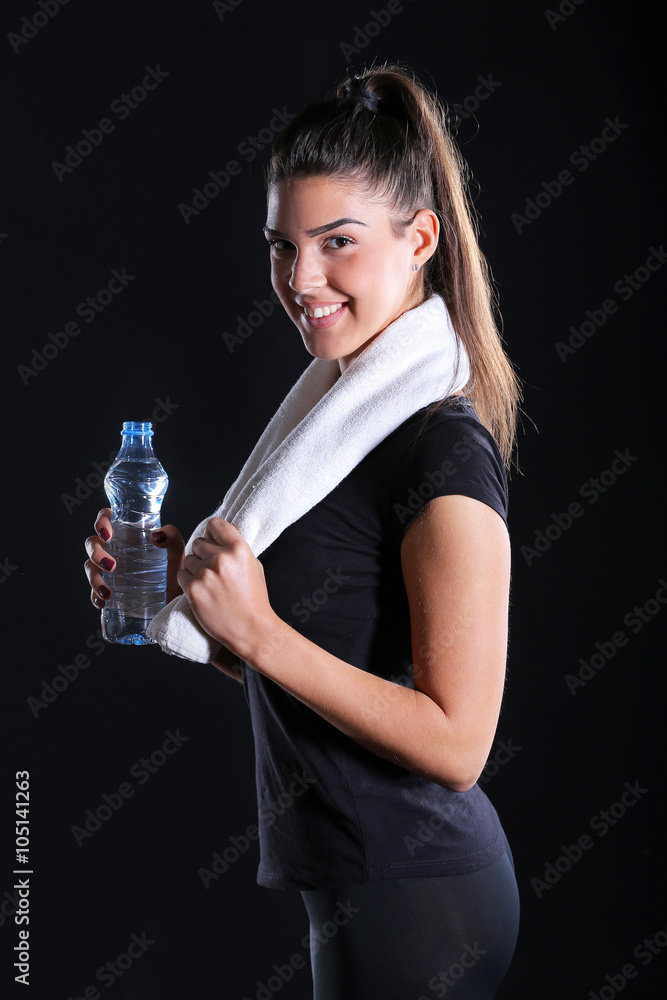 young fitness girl with towel and a bottle of water young fitness girl with towel and a bottle of water