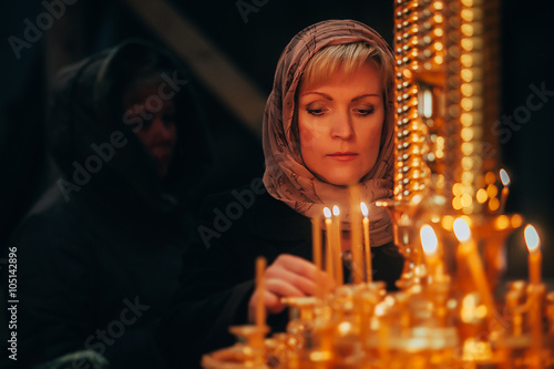 Obraz na plátně Christian russian woman with candle in orthodox russian church