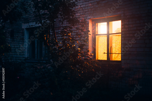 Yellow light from window late at night which makes a cosiness feeleng, the south of Russia