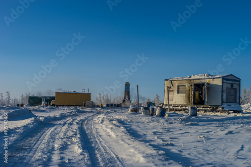 Rig and structures in Winter forest. Season work. Snow and ice road. 