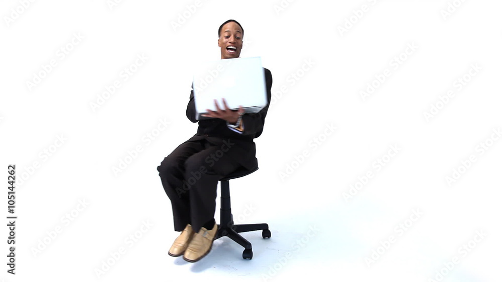 Businessman with laptop spinning in chair Businessman with laptop spinning in chair