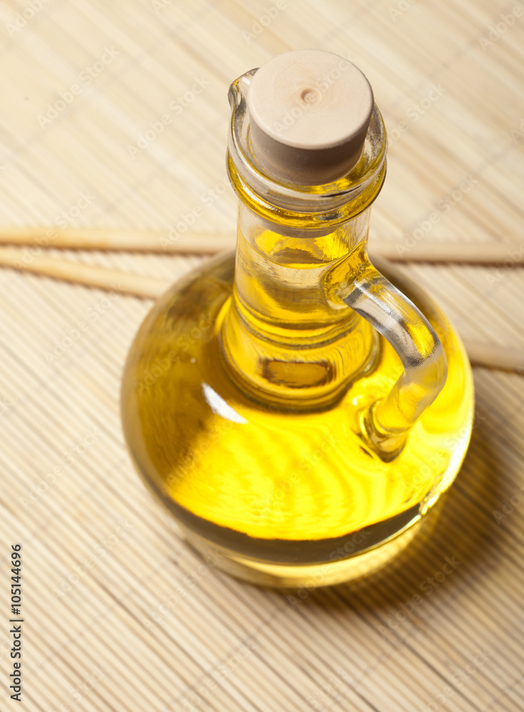 Olive oil and sticks on the wooden background Olive oil and sticks on the wooden background