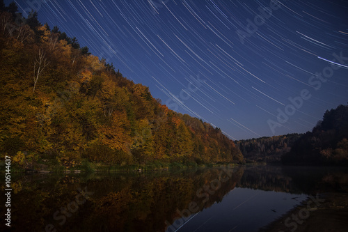  Star trails over the river photo