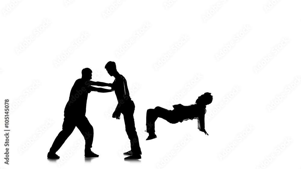 Three young men dancing hip-hop, breakdance on white, silhouette, slow motion Three young men dancing hip-hop, breakdance on white, silhouette, slow motion