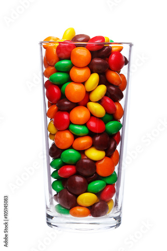 multi colored caramel sweets and chocolate candies in glass isol