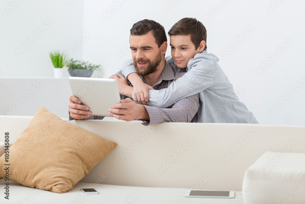 Cheerful parent and teenager are entertaining at home Cheerful parent and teenager are entertaining at home