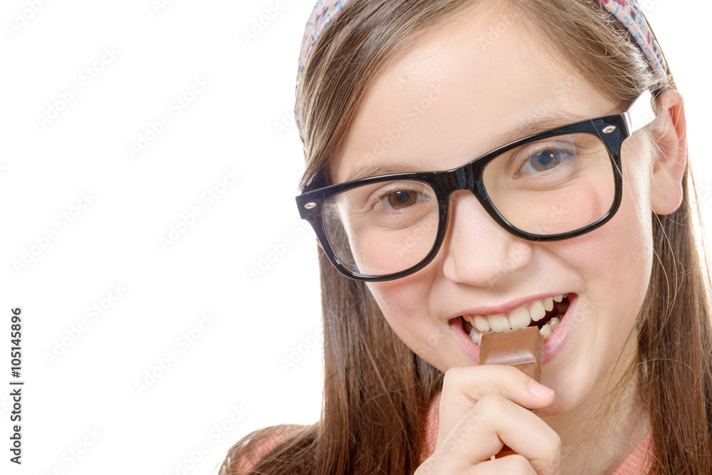 preteen girl eats chocolate, isolated on white preteen girl eats chocolate, isolated on white