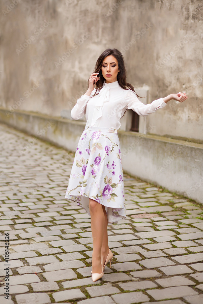 Business woman walking and talking on her phone Business woman walking and talking on her phone