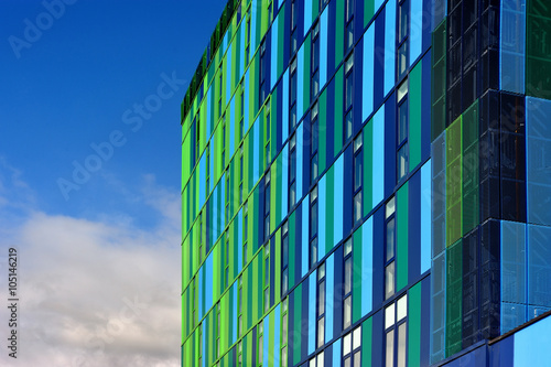 Glass colorful facade with cloudy sky