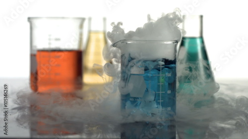 Science beaker bubbling and smoking, slow motion photo