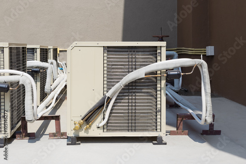 Air compressor or condenser unit outside building. That is part of mini split system or ductless system type. For removing heat and moisture from indoor or room. Also temperature and humidity control.