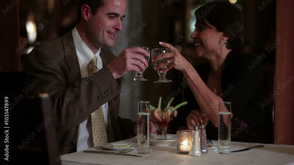 Couple toasts at restaurant Couple toasts at restaurant