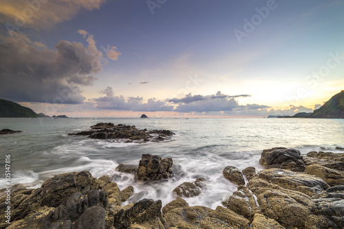 Natural rock with strong water wave and sunrise background at Belanak Beach, Lombok, Indonesia