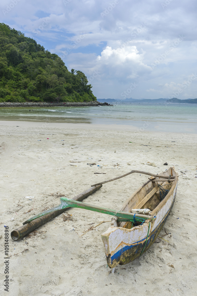 Traditional fisherman wooden boat with cloudy skies at Lombok Selatan, Indonesia Traditional fisherman wooden boat with cloudy skies at Lombok Selatan, Indonesia