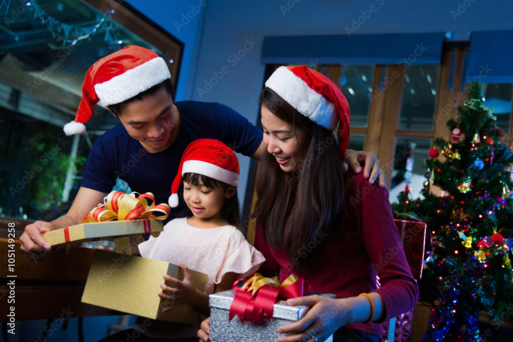 Asian family opening a gift box on christmas day happy Asian family opening a gift box on christmas day happy
