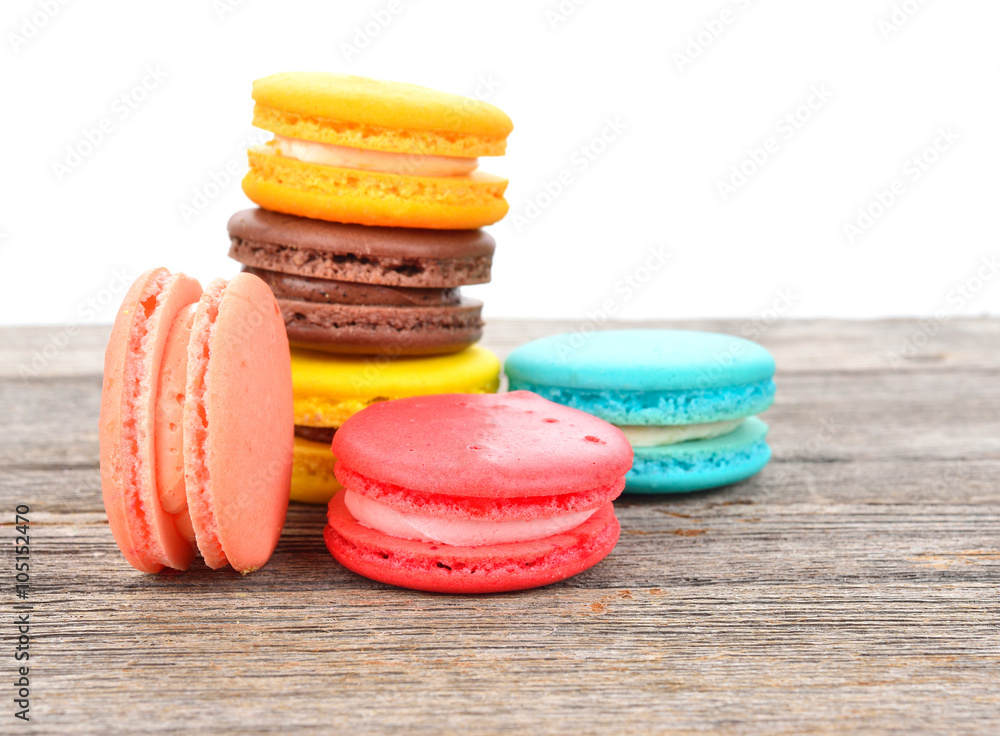 close up of colorful macarons on wooden texture close up of colorful macarons on wooden texture