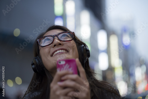 Young women are using to music with a headphone  #105154292