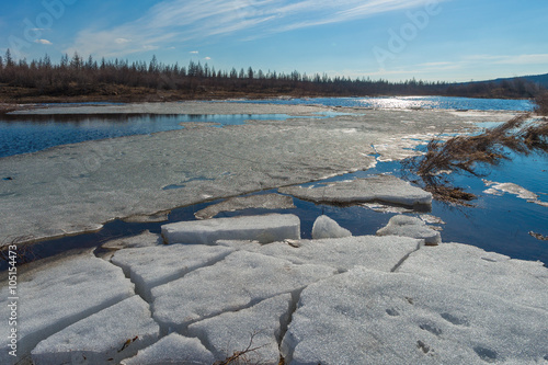 Photos Spring day landscape with debacle, river and forest and clouds on blue sky