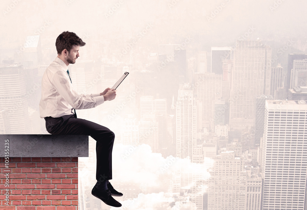 Office worker sitting on rooftop in city Office worker sitting on rooftop in city