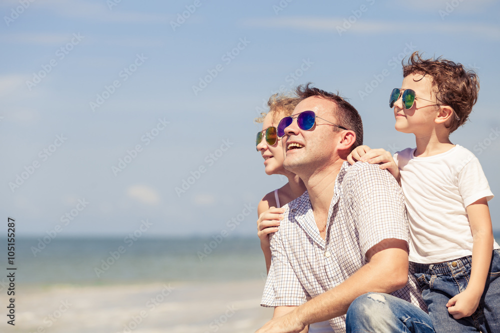 Father and children sitting on the beach at the day time. Father and children sitting on the beach at the day time.