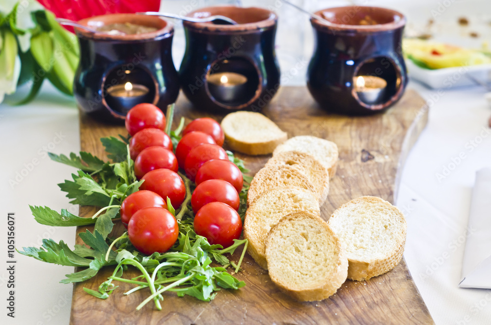 A delicious appetizer with cherry tomatoes, arugula and bruschetta A delicious appetizer with cherry tomatoes, arugula and bruschetta