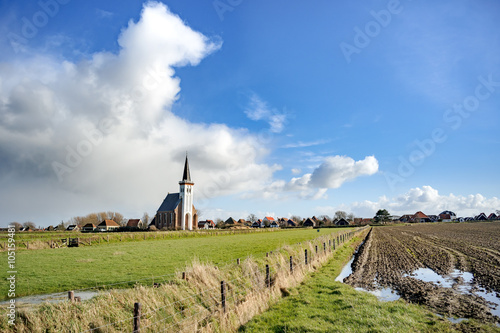 Typical white church in landscape at the island, Texel, Holland photo
