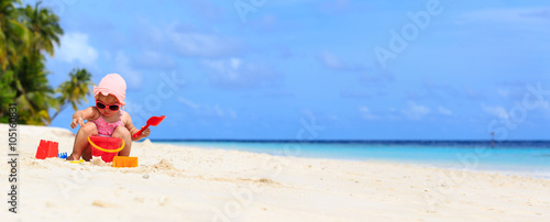 cute little girl play with sand on the beach © nadezhda1906