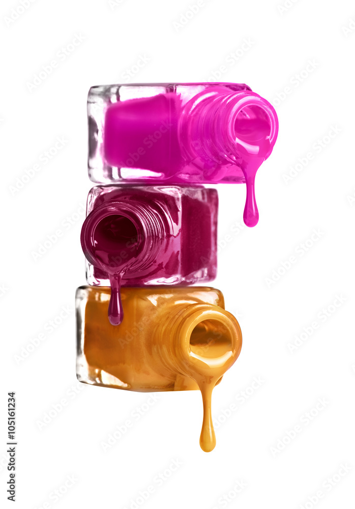 Bottles with spilled nail polish over white background Bottles with spilled nail polish over white background