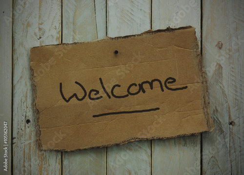 Cardboard sign on a wooden background