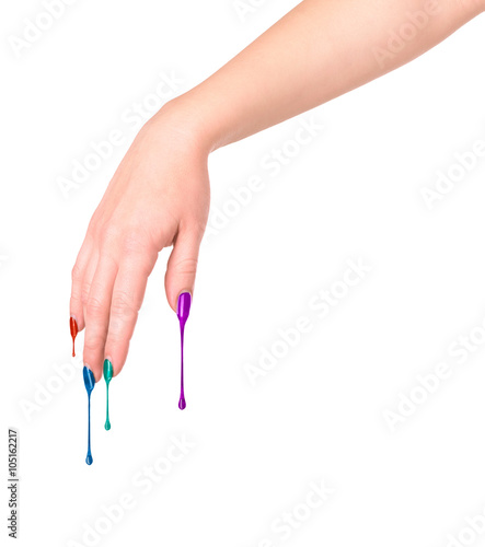 Female nails painted colored . Nail polish dripping on the nail