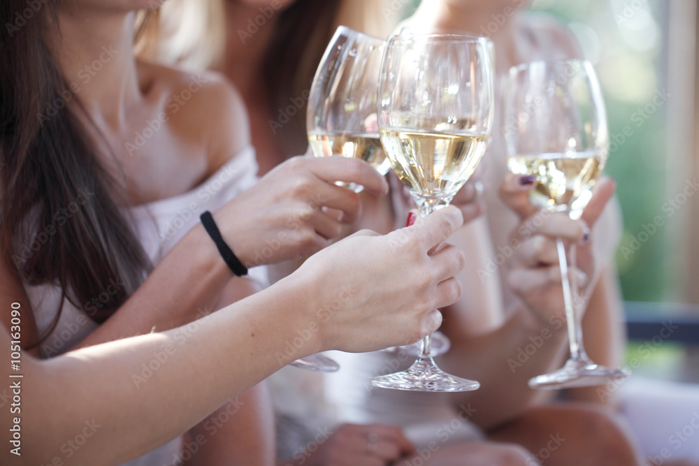 Happy friends toasting wine