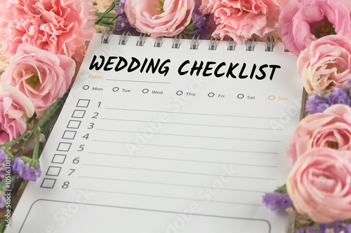 word wedding checklist note paper on pink flower background