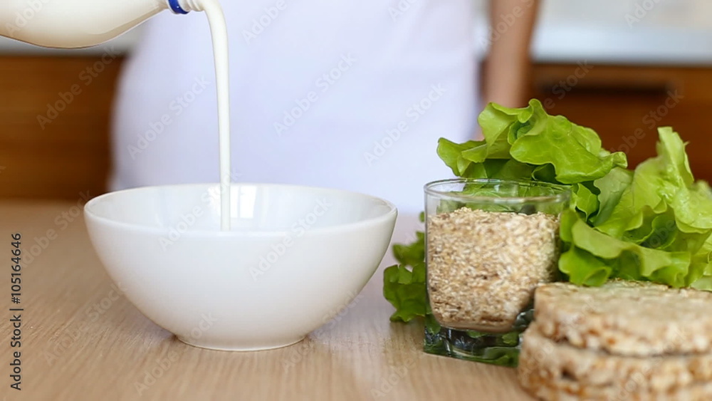 Corn flakes in a bowl pouring with milk Corn flakes in a bowl pouring with milk