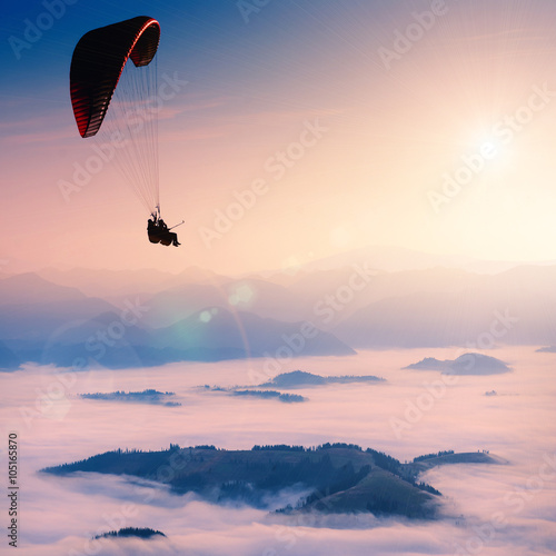 Paraglide in a morning sky