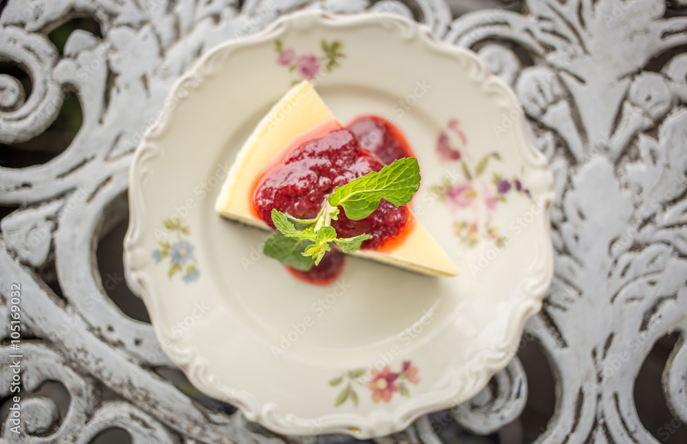 Dessert - Cheesecake with Berries Sauce and Green Mint, top view Dessert - Cheesecake with Berries Sauce and Green Mint, top view