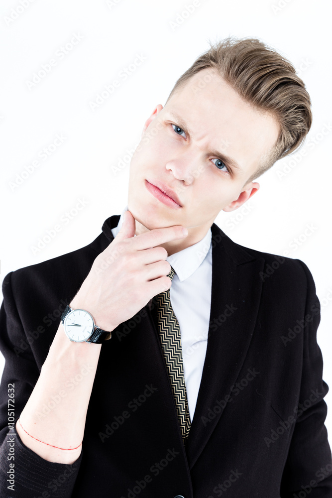Close up picture of an elegant young fashion man wearing black suit on gray background Close up picture of an elegant young fashion man wearing black suit on gray background