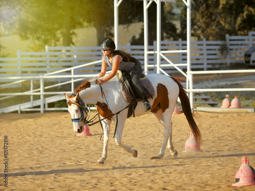 young girl is riding a horse